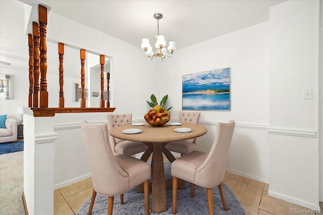 dining room with light tile patterned flooring and a notable chandelier