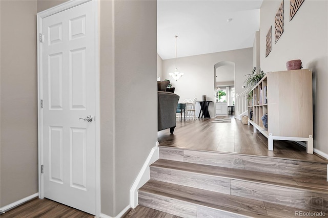 4912 S Fultondale Way, Aurora, CO 80016 - stairway featuring arched walkways, wood finished floors, and a high ceiling
