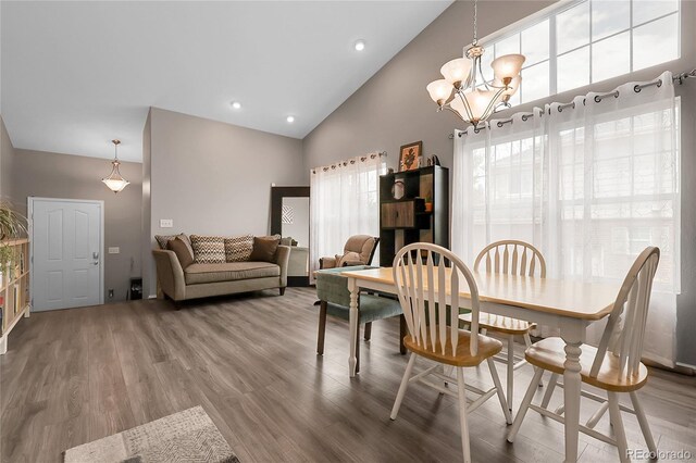 4912 S Fultondale Way, Aurora, CO 80016 - dining room with a chandelier, wood finished floors, and high vaulted ceiling