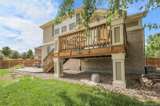 4912 S Fultondale Way, Aurora, CO 80016 - rear view of house featuring brick siding, a wooden deck, a patio, and stairs