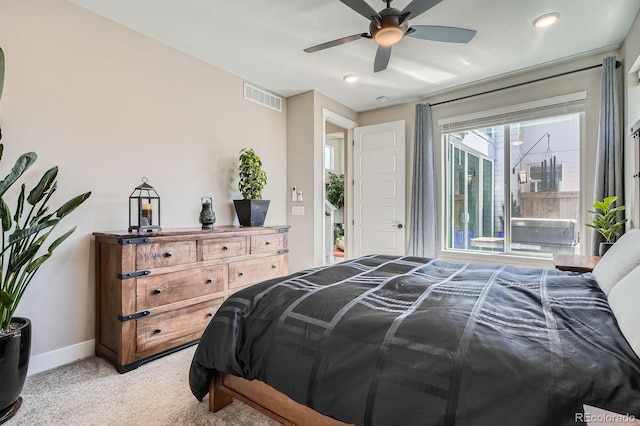 bedroom with visible vents, light colored carpet, a ceiling fan, and baseboards