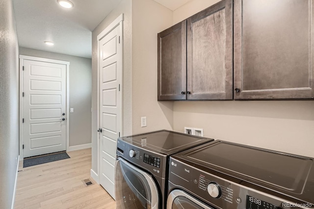 laundry room featuring baseboards, washer and clothes dryer, recessed lighting, light wood-style floors, and cabinet space