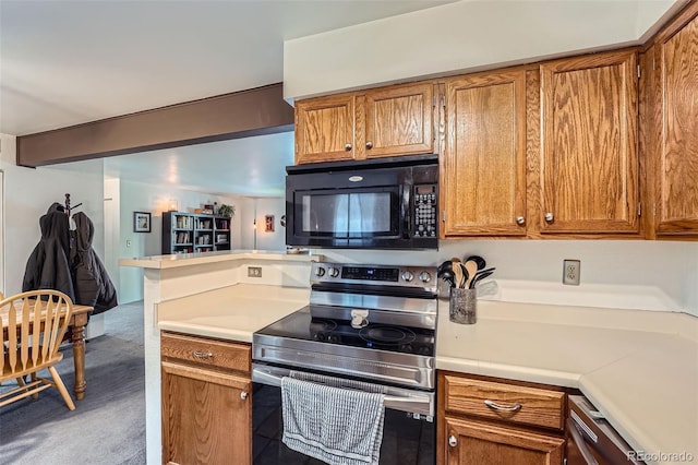 kitchen with stainless steel electric range oven and carpet floors