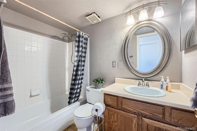 full bathroom with vanity, a textured ceiling, toilet, and shower / tub combo