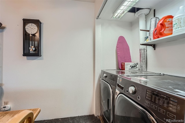 washroom with washing machine and clothes dryer