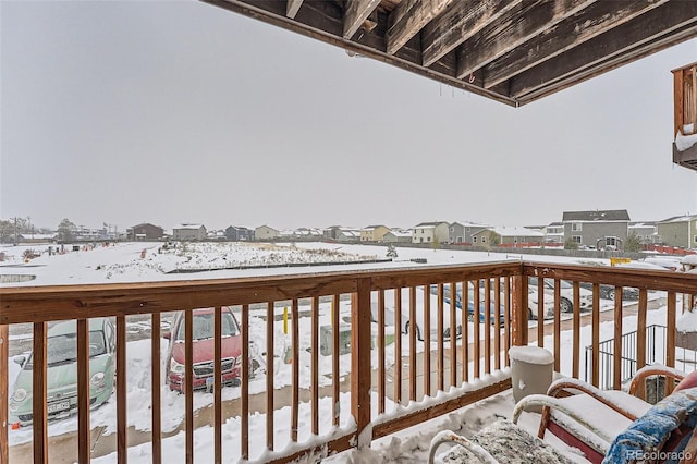 view of snow covered back of property