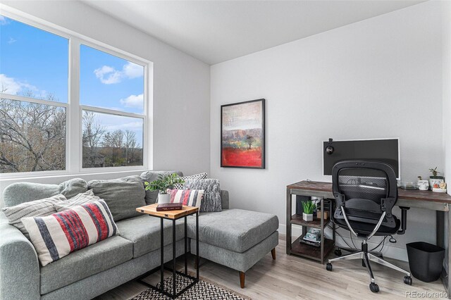 office with baseboards and light wood-style floors