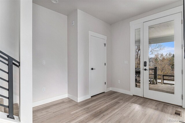 interior space featuring wood finished floors, visible vents, and baseboards