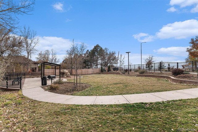 surrounding community featuring a lawn and fence