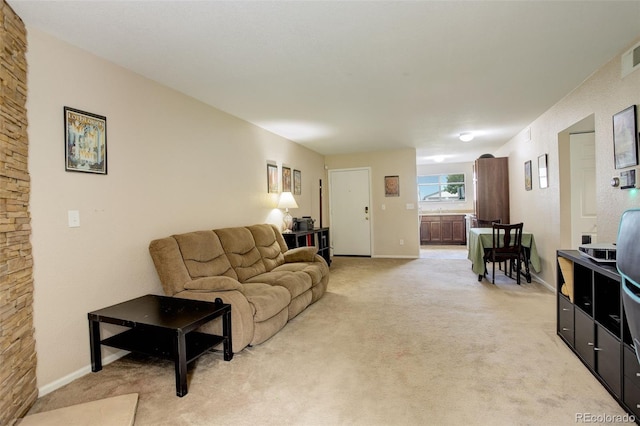 3518 S Depew St Unit 102, Lakewood, CO 80235 - living area featuring light carpet and baseboards