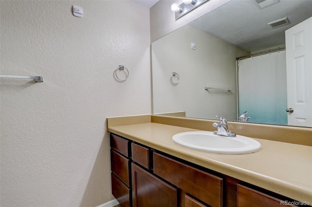 3518 S Depew St Unit 102, Lakewood, CO 80235 - bathroom featuring vanity and a textured wall