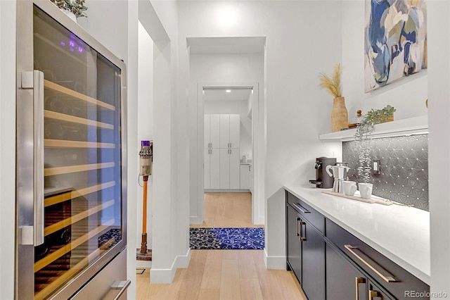 4520 W Moncrieff Pl, Denver, CO 80212 - bar with beverage cooler and light wood-style flooring