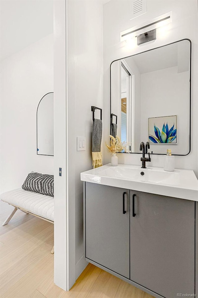 4520 W Moncrieff Pl, Denver, CO 80212 - bathroom with wood finished floors and vanity