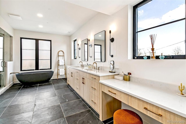 4520 W Moncrieff Pl, Denver, CO 80212 - bathroom with a freestanding tub, double vanity, and recessed lighting