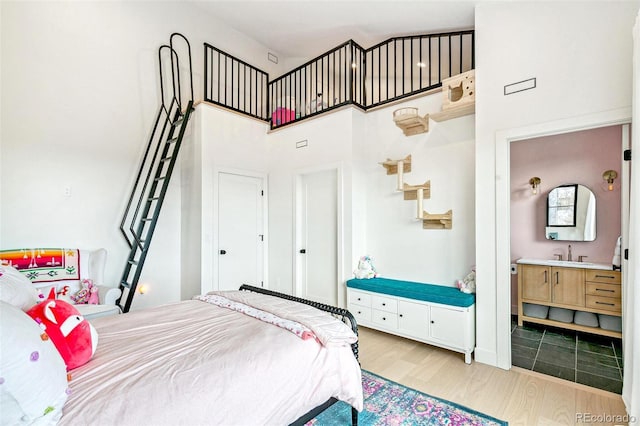 4520 W Moncrieff Pl, Denver, CO 80212 - bedroom with a high ceiling, wood finished floors, and connected bathroom