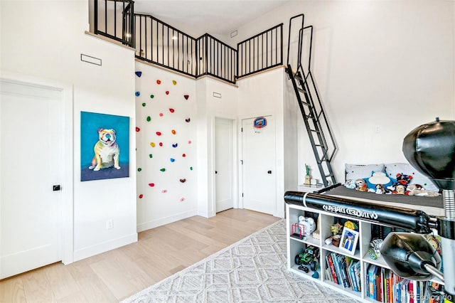 4520 W Moncrieff Pl, Denver, CO 80212 - bedroom featuring a towering ceiling and wood finished floors