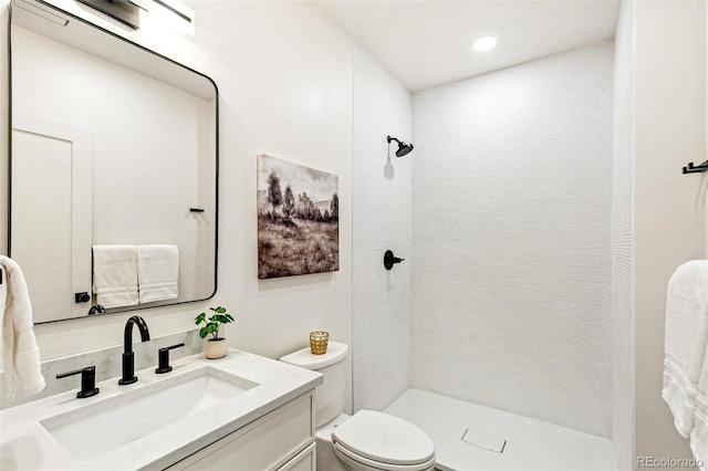 4520 W Moncrieff Pl, Denver, CO 80212 - bathroom with tiled shower, vanity, and recessed lighting