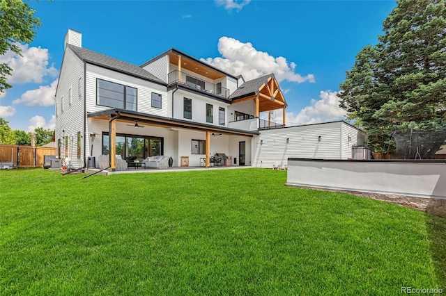 4520 W Moncrieff Pl, Denver, CO 80212 - back of house with a balcony, a patio area, a ceiling fan, a chimney, and outdoor lounge area
