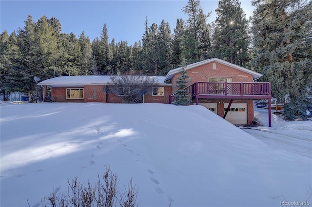 view of front of home featuring a wooden deck and a garage