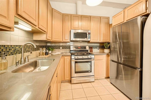 1140 Columbine St Unit 106, Denver, CO 80206 - kitchen featuring appliances with stainless steel finishes, a sink, light brown cabinetry, light tile patterned floors, and tasteful backsplash