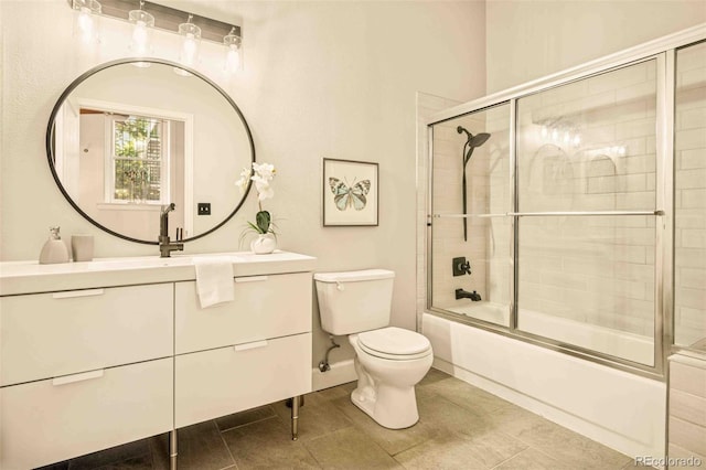 1140 Columbine St Unit 106, Denver, CO 80206 - bathroom featuring toilet, vanity, combined bath / shower with glass door, tile patterned floors, and baseboards