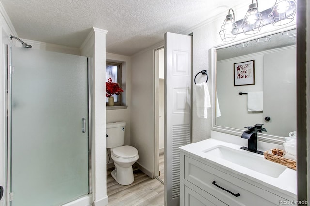 full bath with toilet, a shower stall, wood finished floors, and a textured ceiling