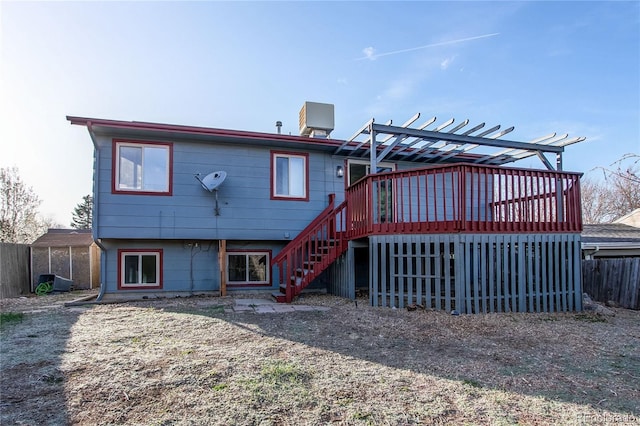 back of property with a pergola, stairs, central AC unit, a wooden deck, and fence