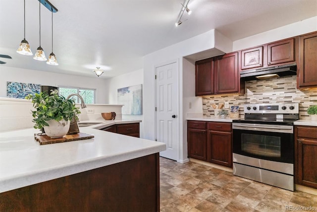 kitchen with backsplash, hanging light fixtures, sink, and electric range