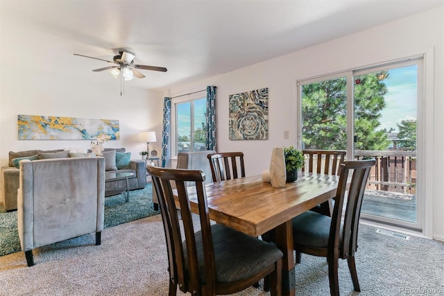 carpeted dining space featuring a wealth of natural light and ceiling fan