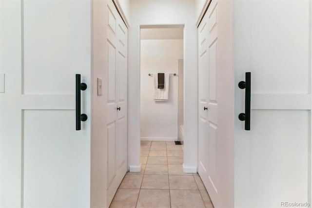 hall with light tile patterned floors