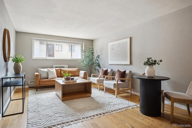 living area with light wood finished floors and baseboard heating