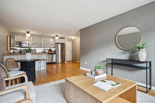 living room featuring light wood-style floors and baseboards