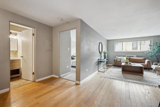 living room with light wood-type flooring and baseboards