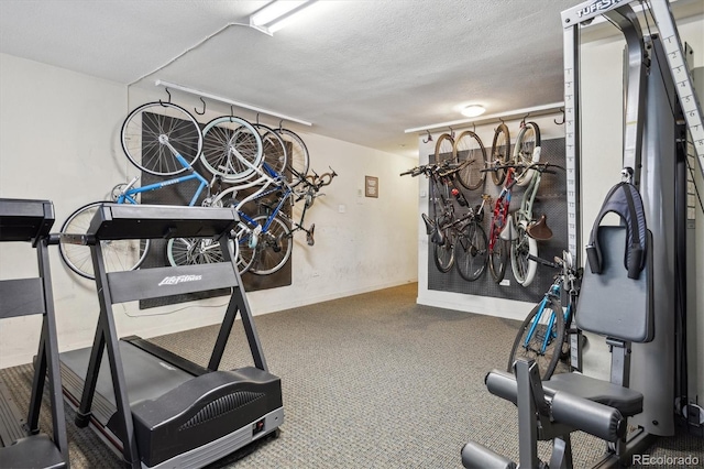 exercise room with carpet floors and baseboards