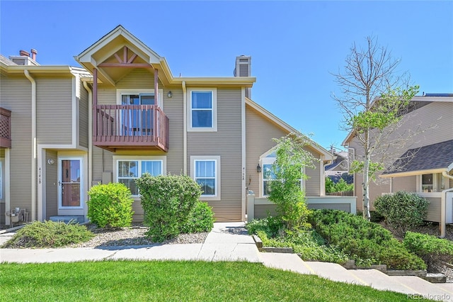 4146 S Mobile Cir Unit A, Aurora, CO 80013 - view of front facade with a chimney, a balcony, and cooling unit