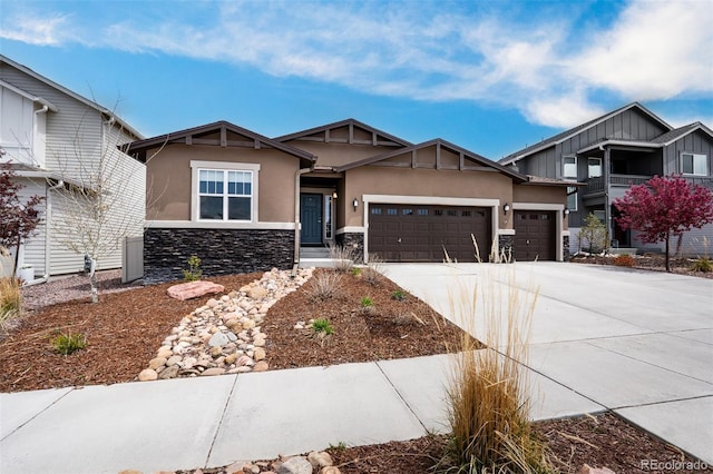 6678 Cumbre Vista Way, Colorado Springs, CO 80924 - craftsman-style house featuring concrete driveway, a garage, stucco siding, and stone siding