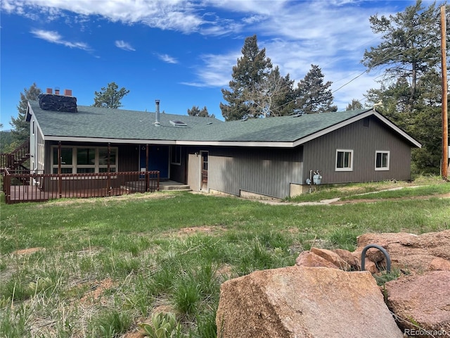 11608 Apache Trl, Conifer, CO 80433 - view of front of home featuring a shingled roof, a patio area, and a front yard