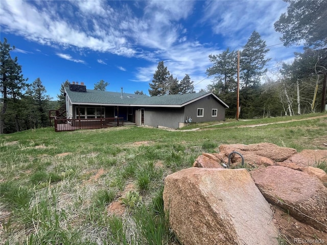 11608 Apache Trl, Conifer, CO 80433 - view of front of house with a deck, a front yard, and a chimney