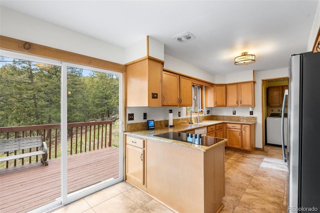 11608 Apache Trl, Conifer, CO 80433 - kitchen with freestanding refrigerator, a peninsula, a sink, washer / clothes dryer, and black electric stovetop