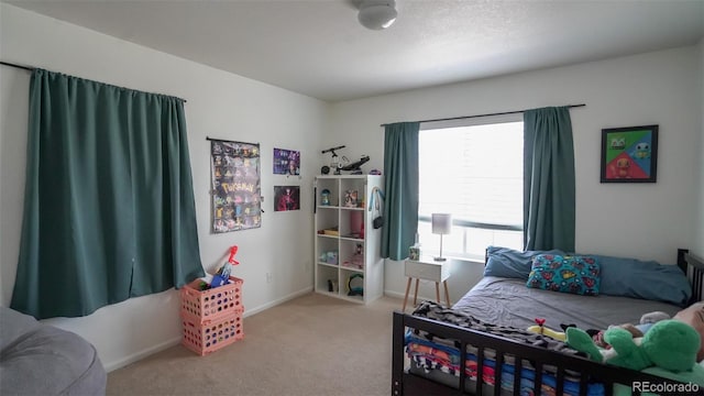 bedroom with baseboards and carpet flooring