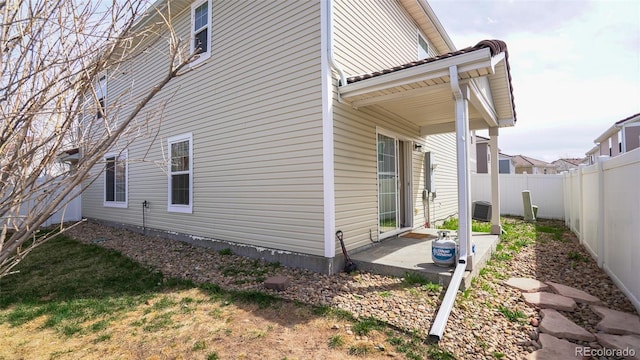 view of side of property with a patio area and a fenced backyard