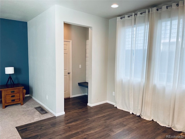 unfurnished bedroom with dark wood-type flooring