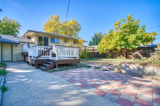 rear view of house with a patio and a deck