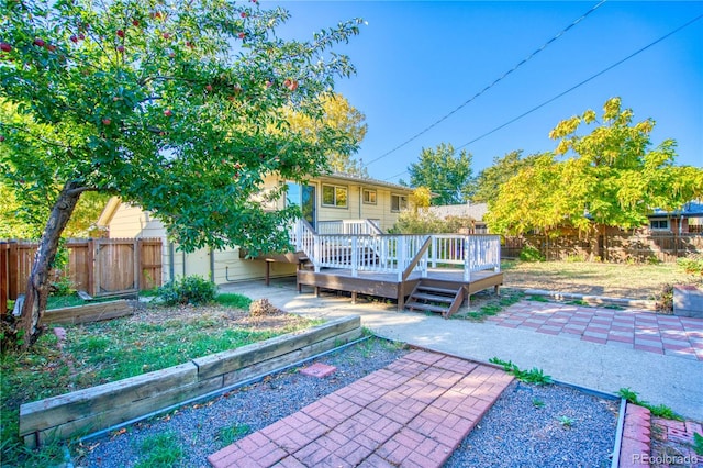 back of property featuring a patio area and a deck