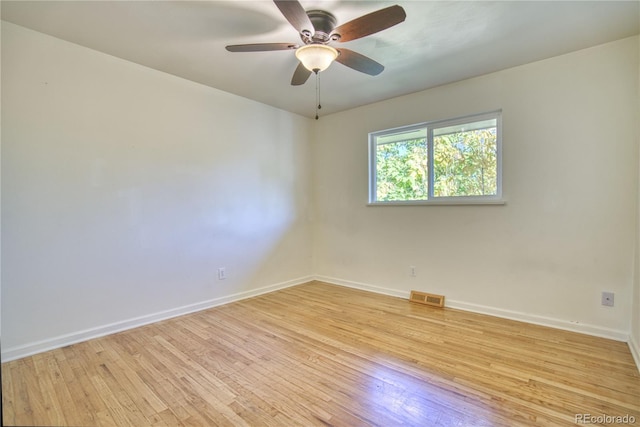 empty room with light hardwood / wood-style flooring and ceiling fan