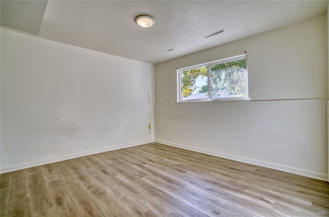 unfurnished room with light hardwood / wood-style flooring