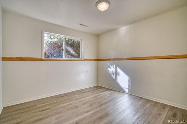 spare room with hardwood / wood-style floors