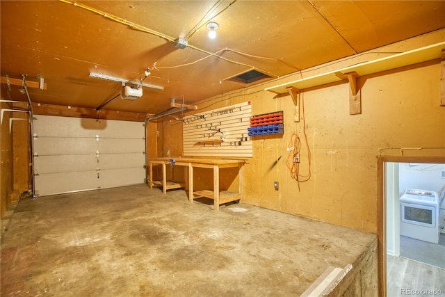 garage featuring a garage door opener and washer / clothes dryer