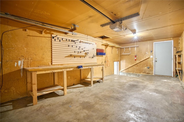 garage featuring a garage door opener and a workshop area