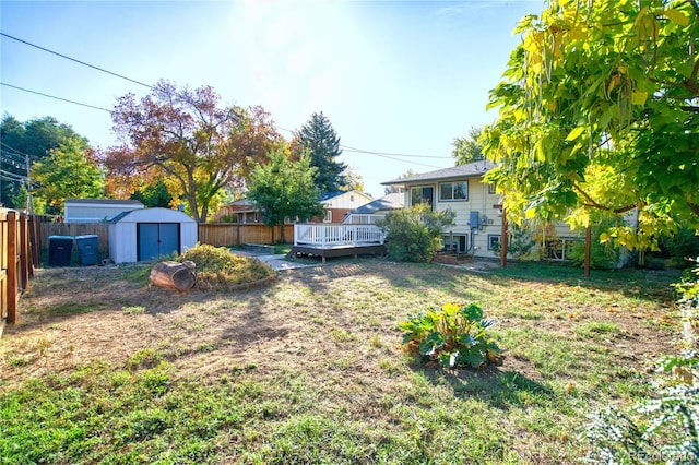 view of yard with a storage shed and a deck